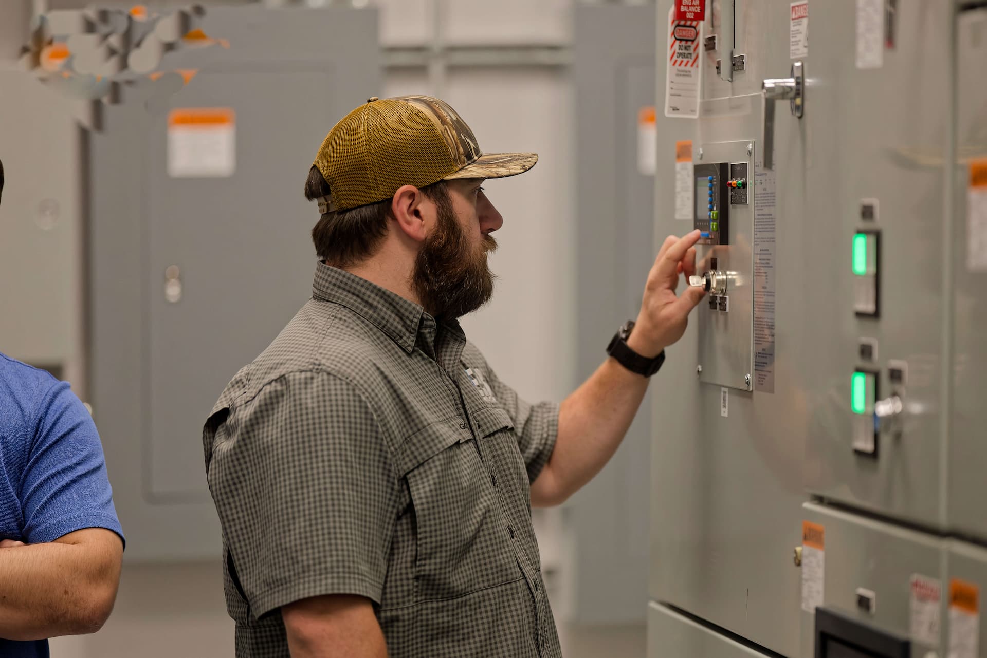 Student operating a panel during electrical commissioning training